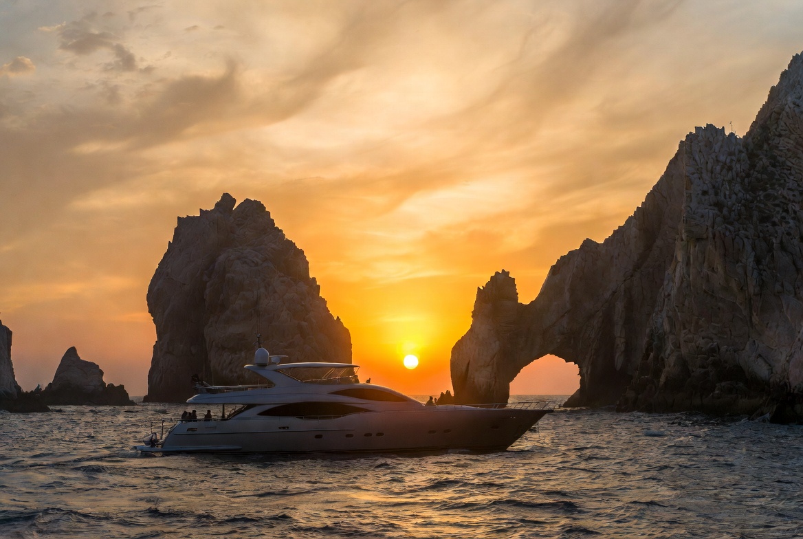 Luxury yacht near Cabo Arch at sunset